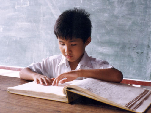 Student reading braille