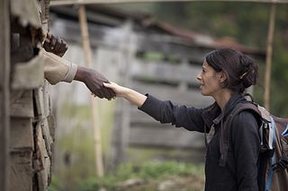 Aid worker shaking hands with hidden prisoner